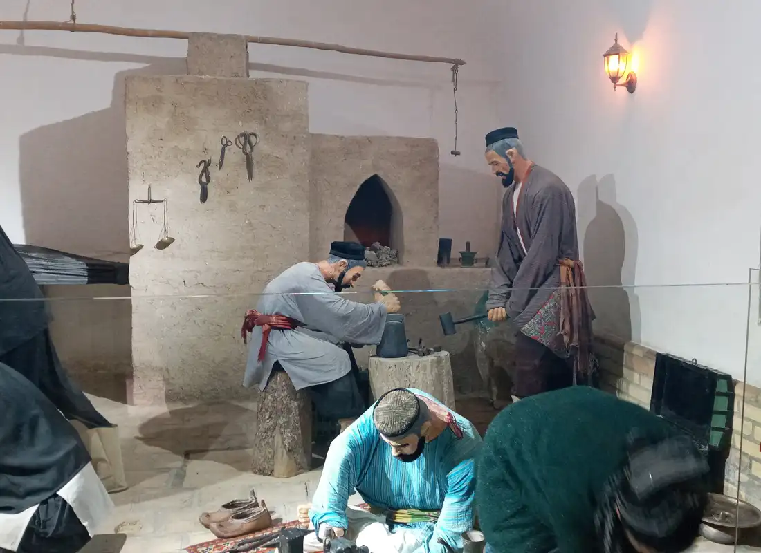 Makers working iron at a forge bench